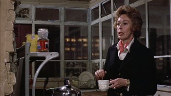 Movie still from “Butterflies Are Free” (1972), directed by Milton Katselas – An older woman is holding a cup of coffee; Medium shot, Over the shoulder angle