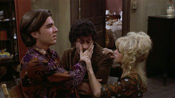 Movie still from “Butterflies Are Free” (1972), directed by Milton Katselas – A group of people sitting in a living room together; Medium shot, High angle