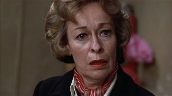 Movie still from “Butterflies Are Free” (1972), directed by Milton Katselas – An older woman wearing a red and white neck tie; Close Up shot, Over the shoulder angle
