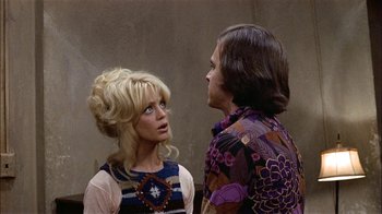 Movie still from “Butterflies Are Free” (1972), directed by Milton Katselas – A man and a woman standing next to each other; Medium shot, High angle