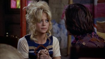 Movie still from “Butterflies Are Free” (1972), directed by Milton Katselas – A woman in a blue and white dress talking to another woman; Close Up shot, Over the shoulder angle