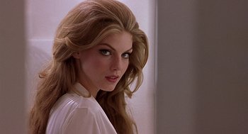Movie still from “CQ” (2001), directed by Roman Coppola – A beautiful woman with long brown hair posing for a picture; Close Up shot, Low angle