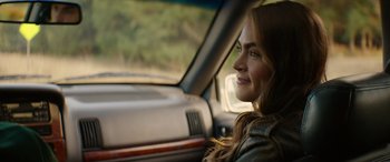 Movie still from “Cabin Fever” (2016), directed by Travis Zariwny – A woman sitting in the passenger seat of a car; Close Up shot, Over the shoulder angle