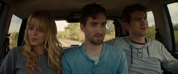 Movie still from “Cabin Fever” (2016), directed by Travis Zariwny – A man sitting in the back seat of a car; Close Up shot, Over the shoulder angle