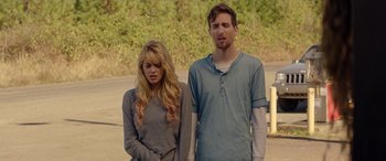 Movie still from “Cabin Fever” (2016), directed by Travis Zariwny – A man and a woman standing next to each other; Medium shot, Low angle