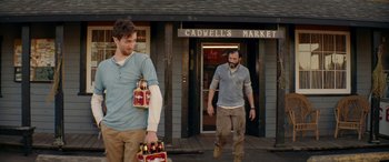 Movie still from “Cabin Fever” (2016), directed by Travis Zariwny – Two men walking down the street holding beer bottles; Medium shot, Low angle