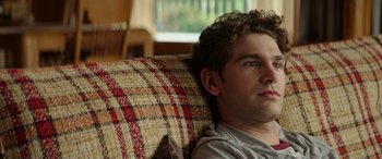 Movie still from “Cabin Fever” (2016), directed by Travis Zariwny – A person laying on a couch; Close Up shot, Over the shoulder angle