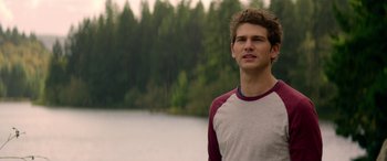 Movie still from “Cabin Fever” (2016), directed by Travis Zariwny – A man standing in front of a body of water; Medium shot, Over the shoulder angle