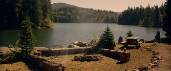 Movie still from “Cabin Fever” (2016), directed by Travis Zariwny – A fire pit in front of the water; Extreme Wide shot, High angle