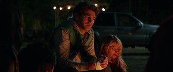 Movie still from “Cabin Fever” (2016), directed by Travis Zariwny – A man and a woman sitting on a bench at night; Medium shot, Over the shoulder angle