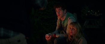 Movie still from “Cabin Fever” (2016), directed by Travis Zariwny – A man and a woman are playing a video game; Medium shot, Over the shoulder angle