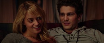 Movie still from “Cabin Fever” (2016), directed by Travis Zariwny – A man and a woman sitting next to each other on a couch; Close Up shot, Over the shoulder angle