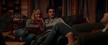 Movie still from “Cabin Fever” (2016), directed by Travis Zariwny – A man and a woman sitting on a couch together; Medium shot, Over the shoulder angle