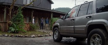 Movie still from “Cabin Fever” (2016), directed by Travis Zariwny – Three men standing in front of a truck; Wide shot, Over the shoulder angle