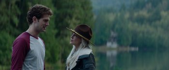 Movie still from “Cabin Fever” (2016), directed by Travis Zariwny – A woman wearing a brown hat and a white scarf; Close Up shot, Over the shoulder angle