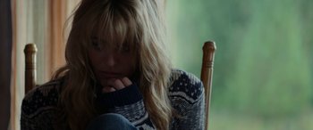 Movie still from “Cabin Fever” (2016), directed by Travis Zariwny – A woman sitting on a chair with her head resting on her hand; Close Up shot, Over the shoulder angle