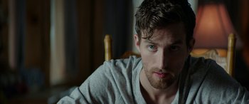 Movie still from “Cabin Fever” (2016), directed by Travis Zariwny – A person sitting in a chair; Close Up shot, Over the shoulder angle