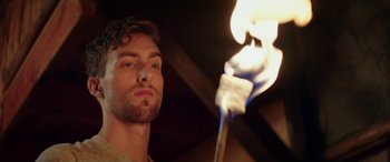 Movie still from “Cabin Fever” (2016), directed by Travis Zariwny – A person holding a lit match stick; Close Up shot, Low angle