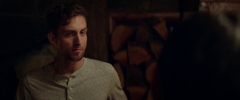 Movie still from “Cabin Fever” (2016), directed by Travis Zariwny – A person wearing a sweater; Close Up shot, Over the shoulder angle