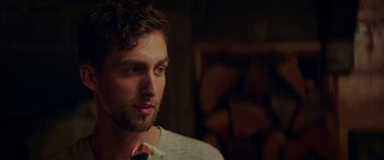 Movie still from “Cabin Fever” (2016), directed by Travis Zariwny – A person with a beard; Close Up shot, Over the shoulder angle