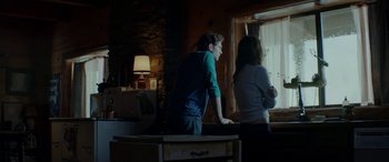 Movie still from “Cabin Fever” (2016), directed by Travis Zariwny – A man and a woman standing in front of a window; Medium shot, Over the shoulder angle