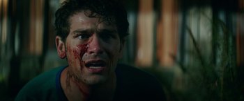 Movie still from “Cabin Fever” (2016), directed by Travis Zariwny – A person with blood on his face; Close Up shot, Low angle