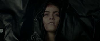 Movie still from “Cabin Fever” (2016), directed by Travis Zariwny – A woman with a black jacket on her head and face; Close Up shot, Overhead angle