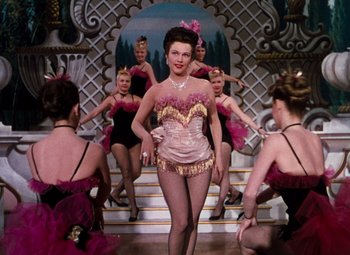 Movie still from “Calamity Jane” (1953), directed by David Butler – A group of women are performing a dance number; Medium shot, Low angle