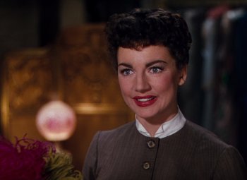 Movie still from “Calamity Jane” (1953), directed by David Butler – A person wearing a suit and tie; Close Up shot, Over the shoulder angle