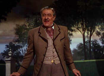 Movie still from “Calamity Jane” (1953), directed by David Butler – An older man wearing a suit and a tie; Medium shot, Low angle