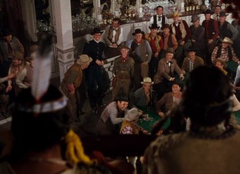 Movie still from “Calamity Jane” (1953), directed by David Butler – A group of men sitting in a room; Wide shot, High angle