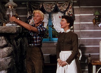 Movie still from “Calamity Jane” (1953), directed by David Butler – A man and a woman standing next to each other; Medium shot, Low angle