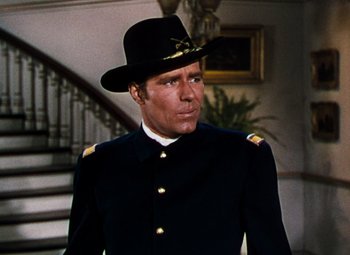 Movie still from “Calamity Jane” (1953), directed by David Butler – A person wearing a uniform and wearing a hat; Close Up shot, Low angle