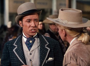 Movie still from “Calamity Jane” (1953), directed by David Butler – A man and a woman wearing hats talking to each other; Medium shot, Over the shoulder angle