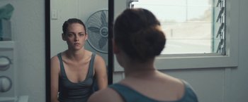 Movie still from “Camp X-Ray” (2014), directed by Peter Sattler – A woman looking at herself in the mirror; Close Up shot, Over the shoulder angle