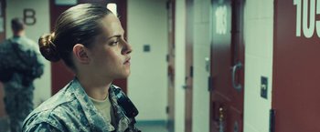 Movie still from “Camp X-Ray” (2014), directed by Peter Sattler – A woman in a military uniform holding a cell phone; Medium shot, Over the shoulder angle