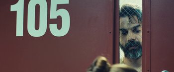 Movie still from “Camp X-Ray” (2014), directed by Peter Sattler – The number 5 on the side of a building; Close Up shot, Over the shoulder angle