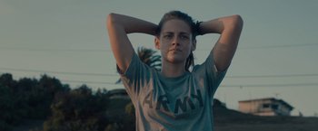 Movie still from “Camp X-Ray” (2014), directed by Peter Sattler – A woman with her hands behind her head; Medium shot, Low angle