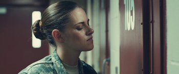 Movie still from “Camp X-Ray” (2014), directed by Peter Sattler – A woman in fatigues is looking down at her face; Close Up shot, Over the shoulder angle