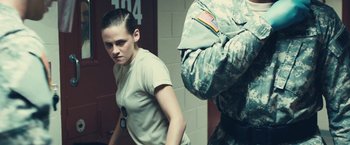 Movie still from “Camp X-Ray” (2014), directed by Peter Sattler – A woman standing next to a man in a uniform; Medium shot, Low angle