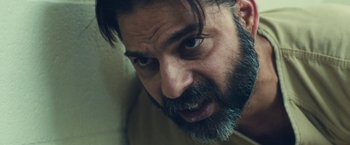 Movie still from “Camp X-Ray” (2014), directed by Peter Sattler – A person with a beard; Close Up shot, Low angle