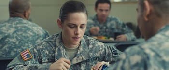 Movie still from “Camp X-Ray” (2014), directed by Peter Sattler – A woman in military fatigues eating a sandwich; Medium shot, Over the shoulder angle