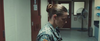 Movie still from “Camp X-Ray” (2014), directed by Peter Sattler – A woman in a military uniform standing next to a door way; Close Up shot, Over the shoulder angle