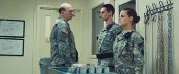 Movie still from “Camp X-Ray” (2014), directed by Peter Sattler – A group of men and women standing next to each other; Medium shot, Over the shoulder angle