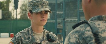Movie still from “Camp X-Ray” (2014), directed by Peter Sattler – A woman in a military uniform is wearing a radio; Close Up shot, Over the shoulder angle