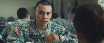 Movie still from “Camp X-Ray” (2014), directed by Peter Sattler – A man in military fatigues sitting in a room; Close Up shot, Over the shoulder angle