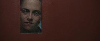 Movie still from “Camp X-Ray” (2014), directed by Peter Sattler – A man looking through a chain link fence; Close Up shot, Over the shoulder angle