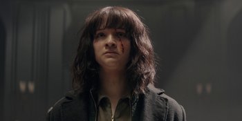 Movie still from “Dark” (2017), created by Baran bo Odar – A person with a black shirt and a black jacket; Close Up shot, Over the shoulder angle