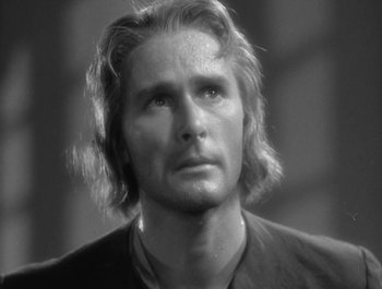 Movie still from “Captain Blood” (1935), directed by Michael Curtiz – Black and white photograph of a man with long blonde hair; Close Up shot, Low angle