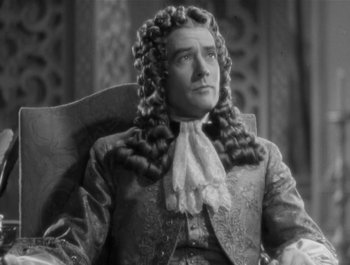 Movie still from “Captain Blood” (1935), directed by Michael Curtiz – An old photo of a man in a wig; Close Up shot, High angle